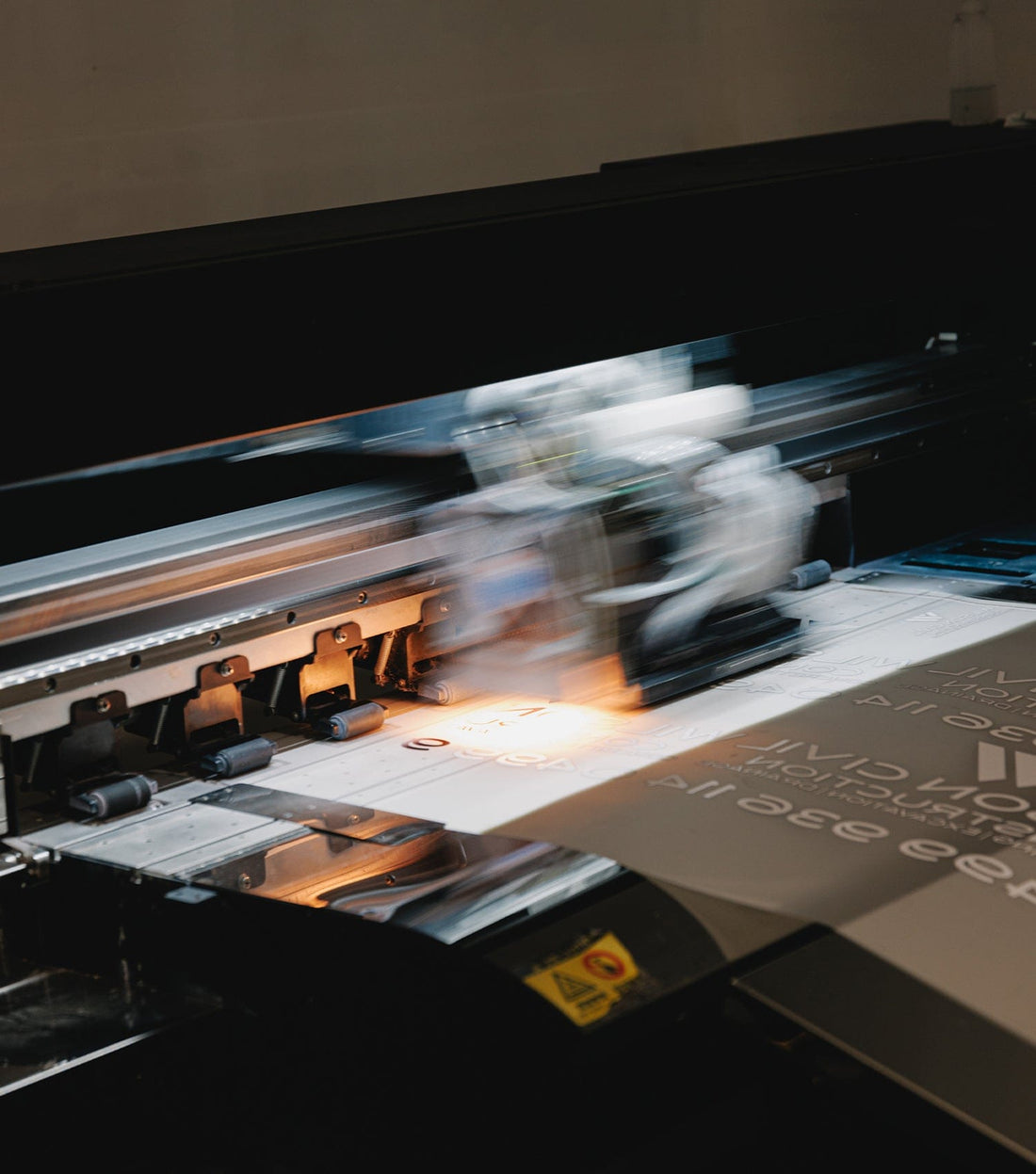 Large-format printer producing a Direct To Film transfer on clear PET film for custom apparel